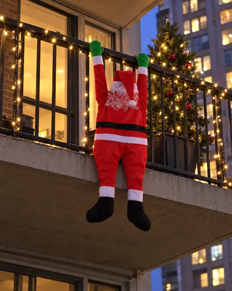 Climbing Santa hanging from an apartment balcony railing